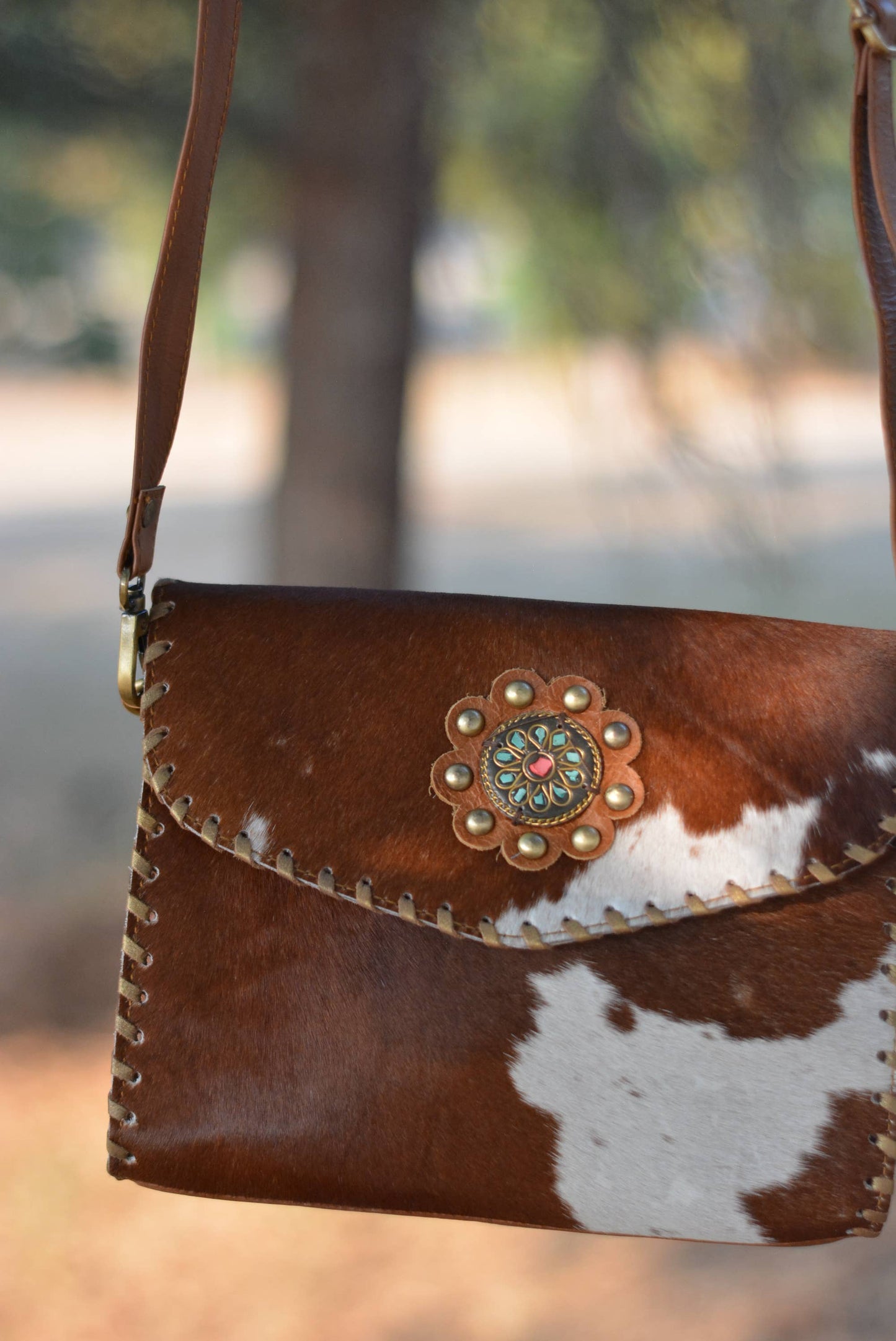 Cowhide Crossbody Bag with Concho Detail
: Brown